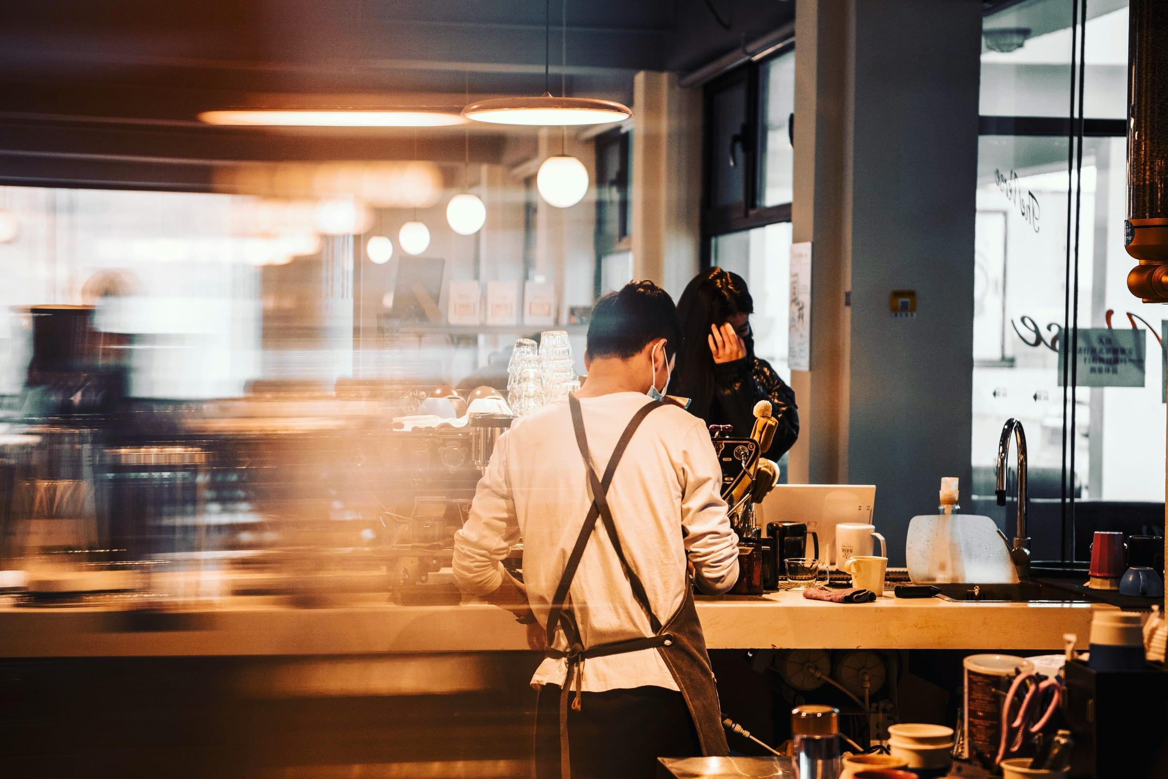 Customers seated in a warmly lit cafe dining room.